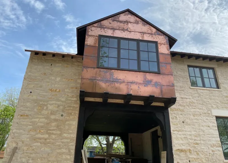 Copper metal panel facade on a stone building for Roof Repair in Grass Valley